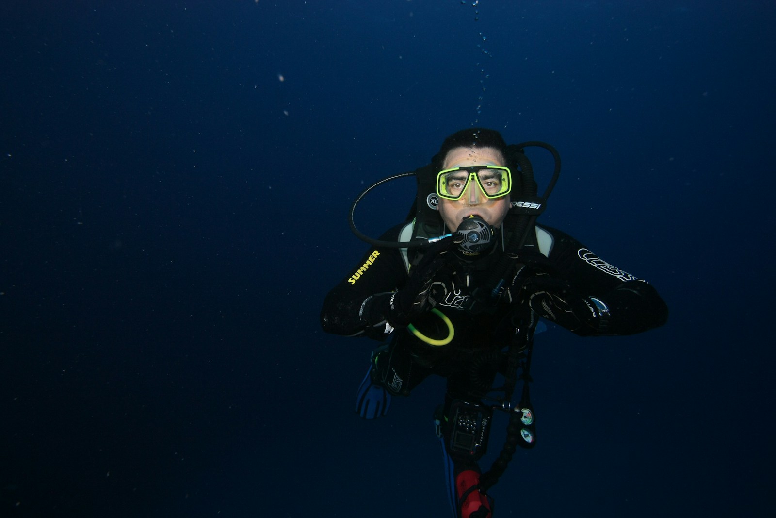 a person in a scuba suit and goggles in the water